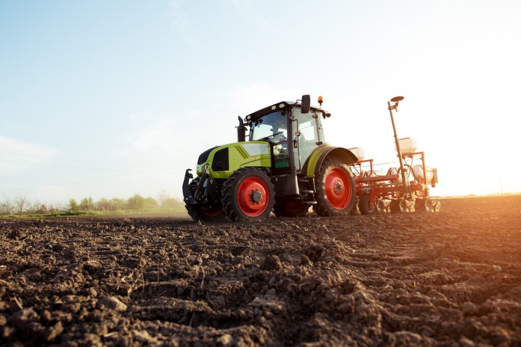 Farmer seeding crops in a field.