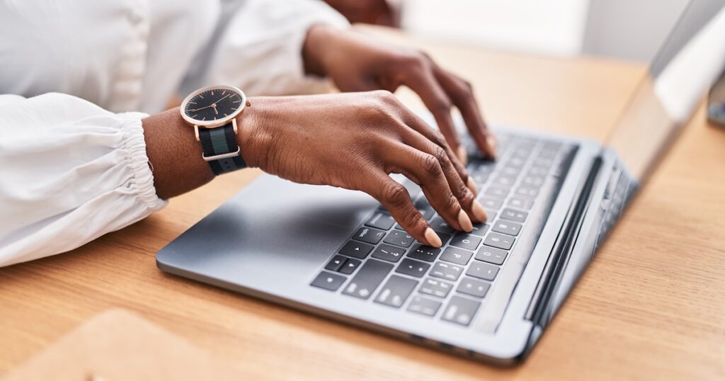 Woman using laptop at office.