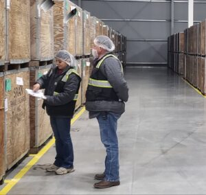 Woman and man standing in a cold storage warehouse.