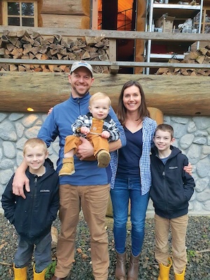 Smiling couple with their three kids.