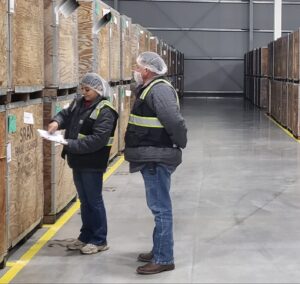 Woman and man standing in a cold storage warehouse.