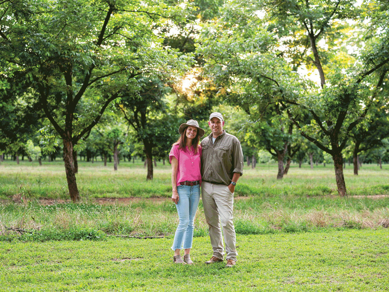 Lanier and Lawton Pearson standing in their orchard.