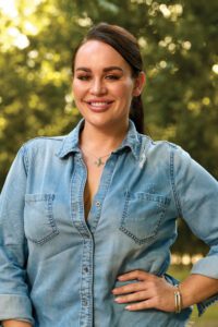 smiling woman with hand on hip