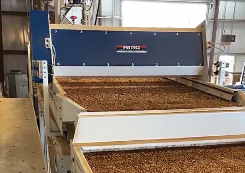 A size grader that is sizing incoming almonds based on counts per ounce.